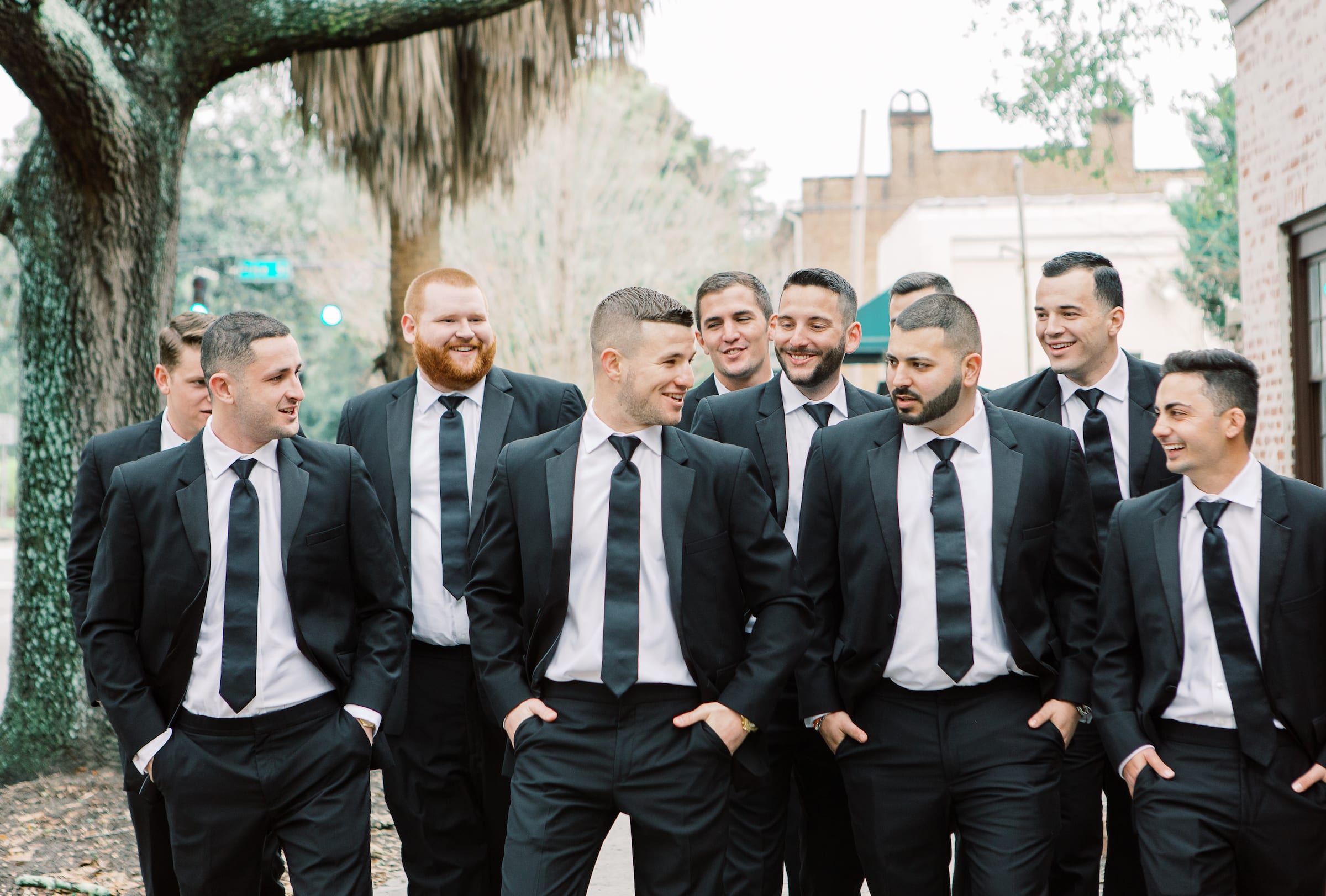groomsmen laughing and walking to the ceremony at this destination savannah wedding taken by a Solo wedding photographer.