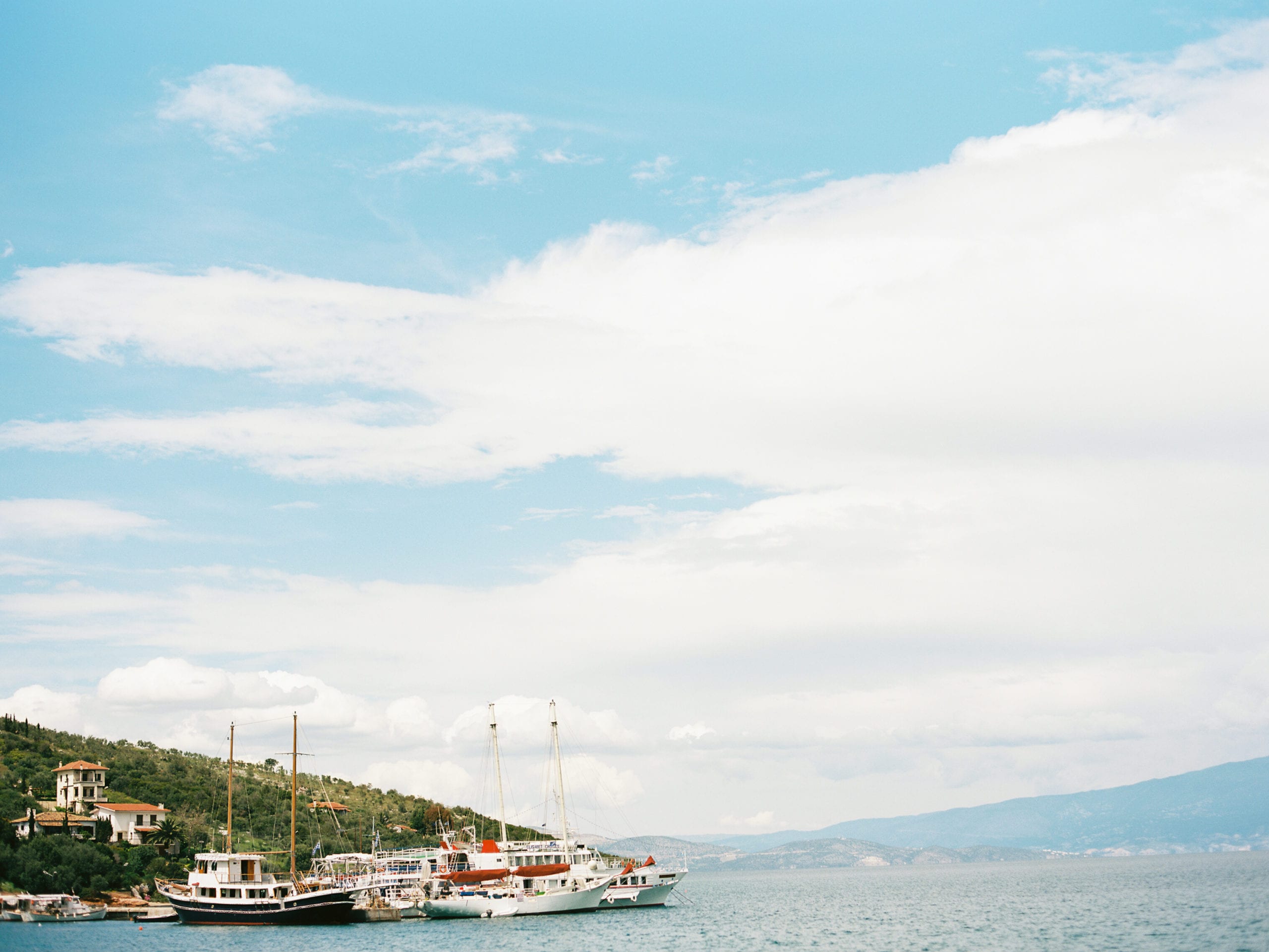 Santorini wedding photographer and destination greece wedding photographer J.J. Au'Clair documents a gorgeous landscape of sailboats.